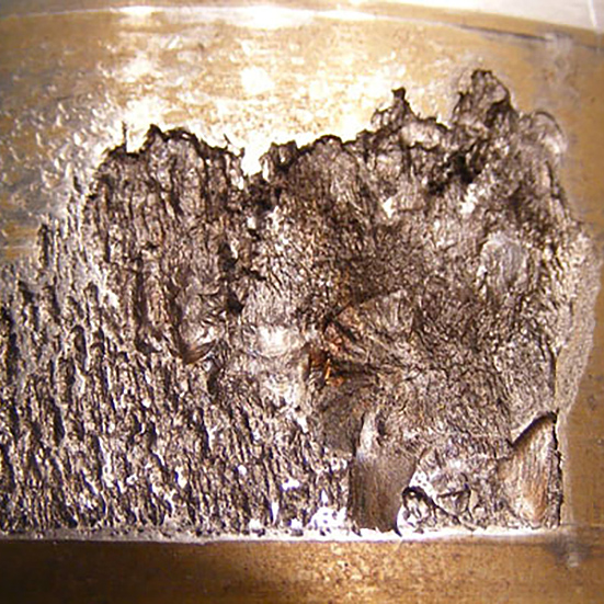 A spherical roller raceway with surface material peeled away