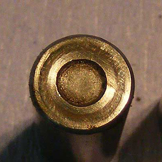 A prominent scoring mark caused by a lack of radial clearance during service rotation. Swirl shaped scuffing and scoring on the ends of a failed taper roller bearing