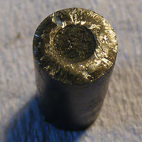 A smeared end of a tapered rolled as a result of excessive sliding contact against the roller retaining rib