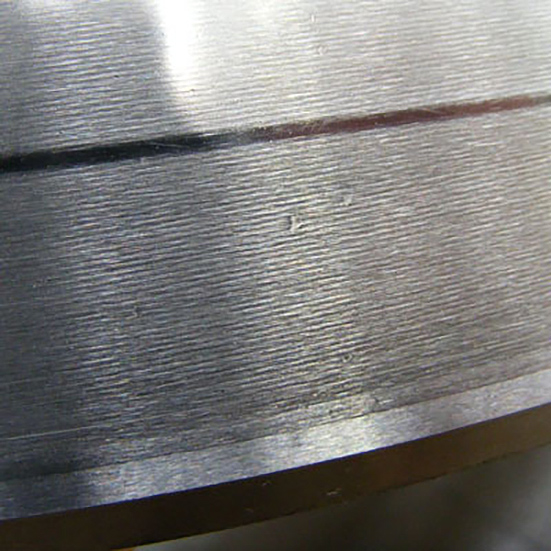 Dented cross roller thrust bearing raceway caused by dirt ingress following a strip down and re assembly