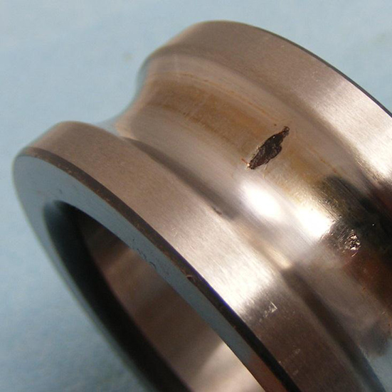 Fatigue occurring on a ball bearing inner ring due to stresses induced around an impact dent