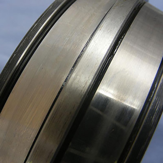 Light pitting as seen on the two sides of a spherical roller inner ring