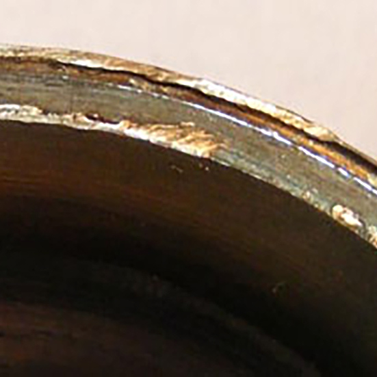 Close up of a Tapered Roller nose with heavy burrs and rotational scuffing due to maladjustment of the bearing on the shaft