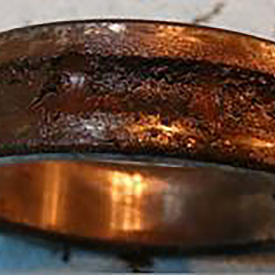 Rusting of a ball bearing inner ring caused by moisture in the lubricant
