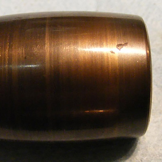 Outer surface scratches caused during fitting. These marks are generally not detrimental to the bearing performance but do show that an interference fit was present between the bearing outer ring and the housing